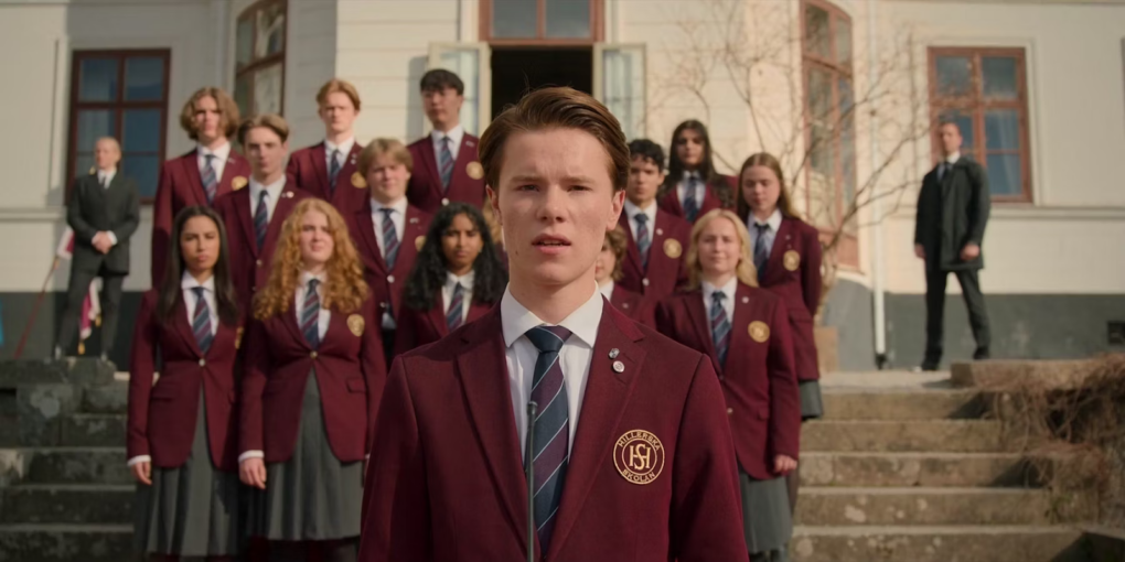 Moment from the series, students gathered in front of the school